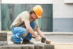 Mason worker making sidewalk pavement