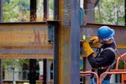 construction worker welding building beam