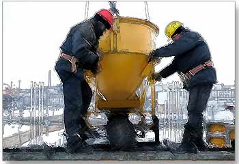 Construction workers pouring concrete