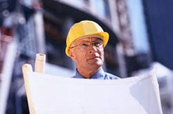 Engineer reviewing drawings as part of a construction quality control plan